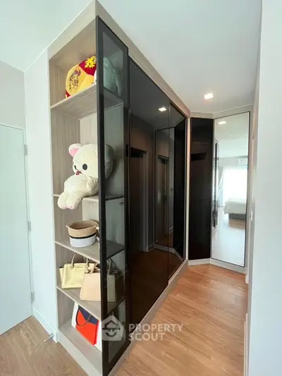Modern bedroom with sleek built-in wardrobe and wooden flooring