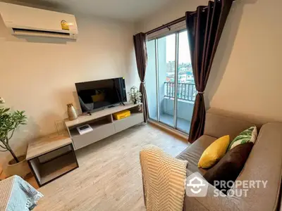 Modern living room with balcony view, stylish decor, and air conditioning in urban apartment.