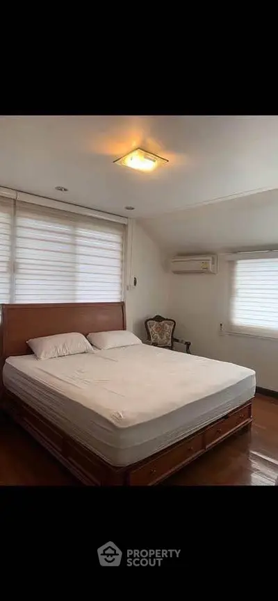 Spacious bedroom with elegant wooden bed and cozy ambiance