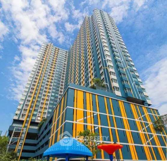 Stunning high-rise building with modern architecture against a blue sky.