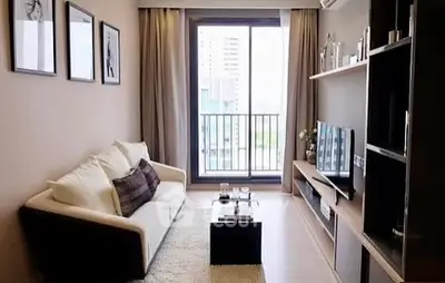 Modern living room with balcony view, stylish decor, and cozy seating area.