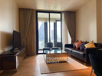 Stylish living room with modern decor and city view balcony in luxury apartment.