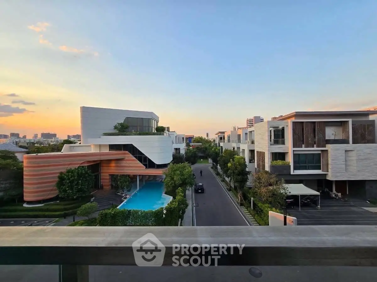 Luxurious modern villas with private pools and stunning sunset views in an upscale neighborhood.