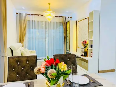 Elegant living room with chandelier, cozy seating, and dining area, perfect for modern living.