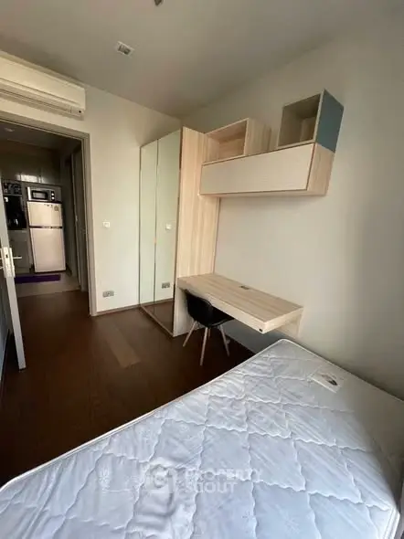 Modern bedroom with built-in desk and wardrobe, featuring sleek design and ample storage.