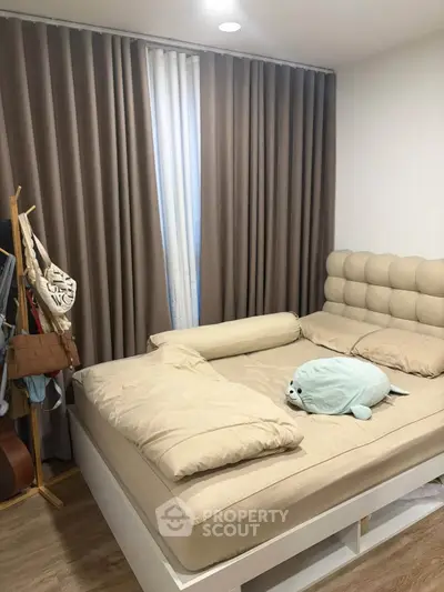 Cozy bedroom with plush bedding and elegant curtains, perfect for relaxation and comfort.