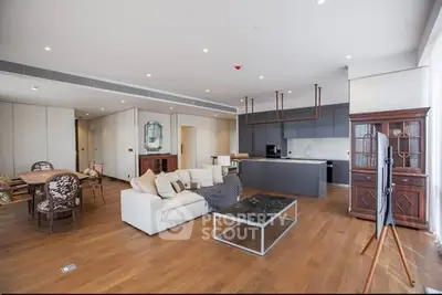 Spacious modern living room with open kitchen and elegant furnishings.