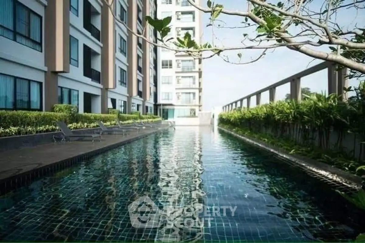 Luxurious condominium with a stunning outdoor pool and lush greenery