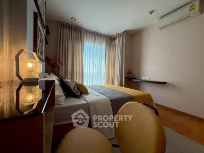 Cozy bedroom with modern decor, large window, and air conditioning unit, perfect for relaxation.