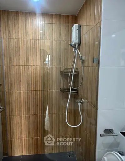 Modern bathroom with sleek shower design and wooden tile accents