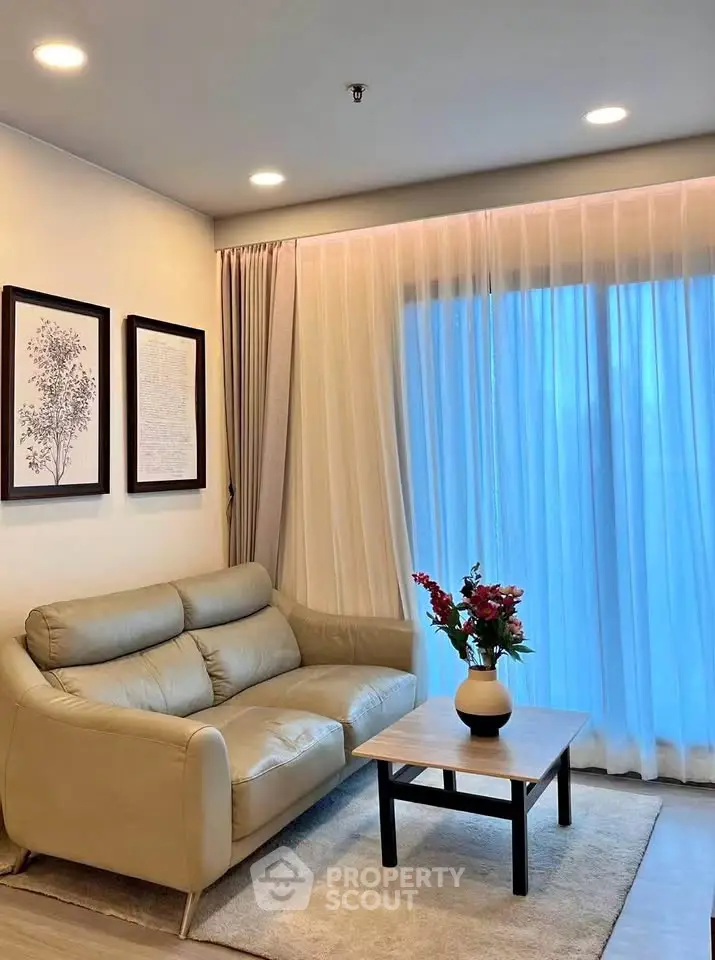 Cozy living room with elegant decor and natural light, featuring a comfortable sofa and stylish coffee table.