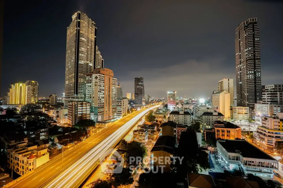 Stunning cityscape view showcasing illuminated skyscrapers and bustling streets at night.
