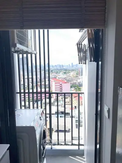 Stunning high-rise balcony view with cityscape and washing machine setup.
