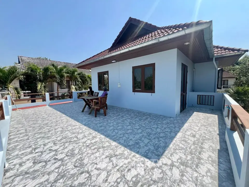 Spacious rooftop terrace with seating area and scenic views, perfect for outdoor relaxation.