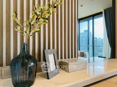 Modern interior with stylish decor and city view from balcony.
