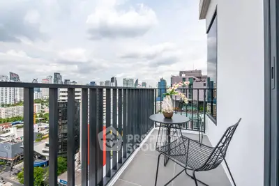Stunning city view from modern high-rise balcony with stylish seating.