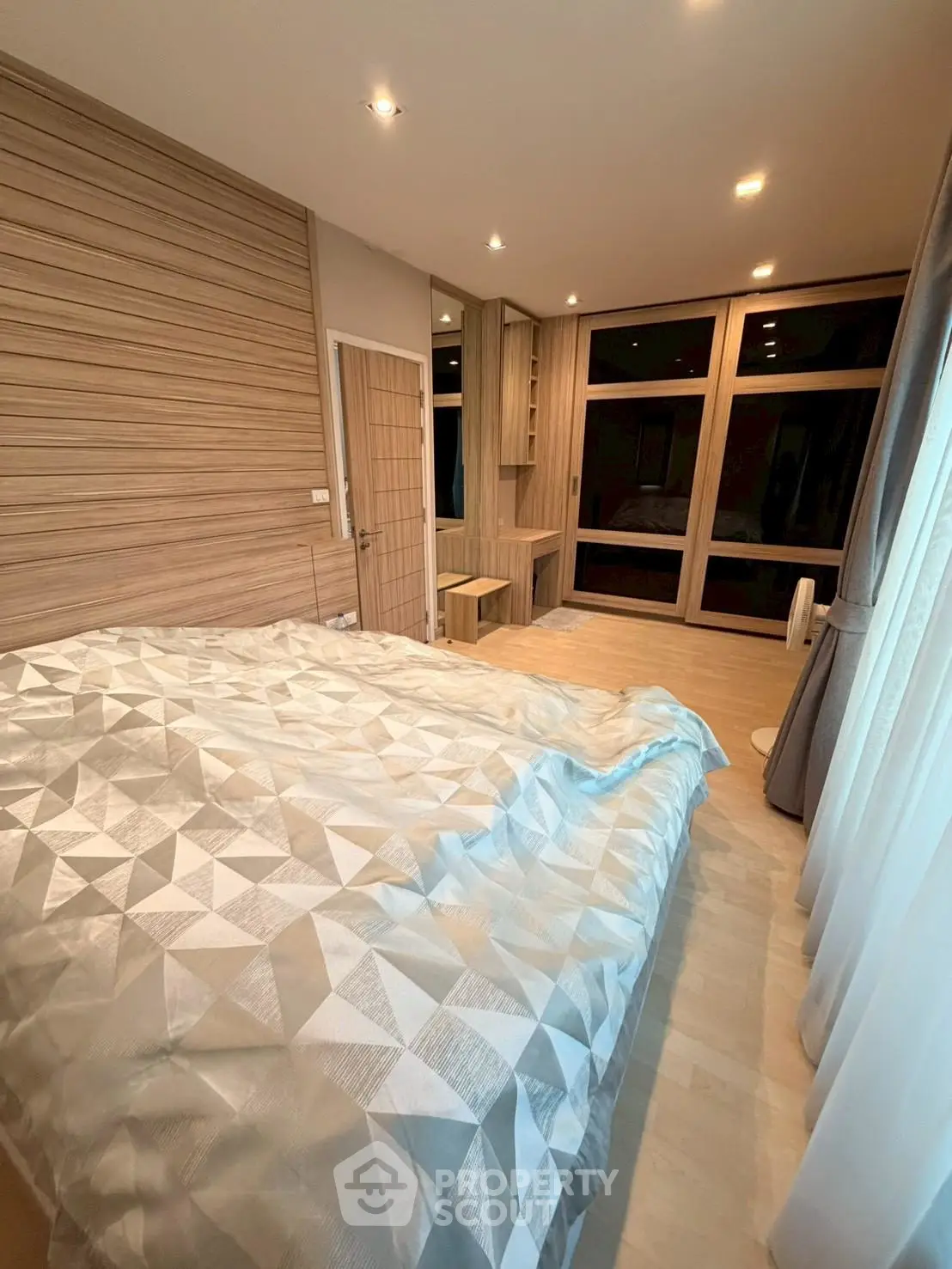 Modern bedroom with stylish decor and large windows for natural light.