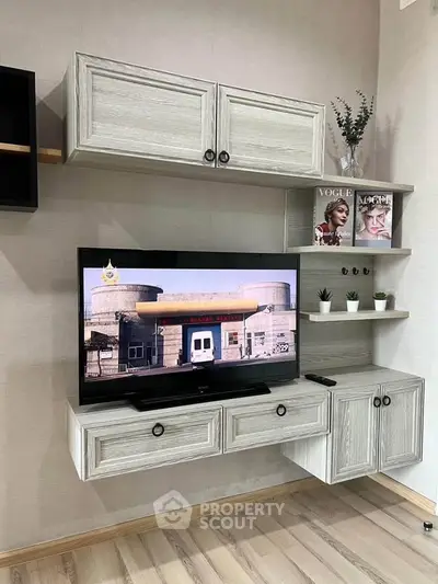 Modern living room with stylish wall-mounted TV unit and decorative shelves