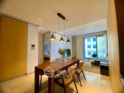 Modern living room with dining area and large windows in a stylish apartment.