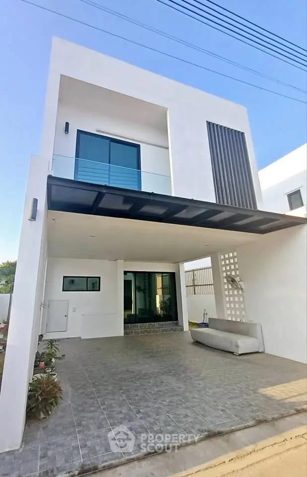 Modern two-story white house with sleek design and spacious driveway