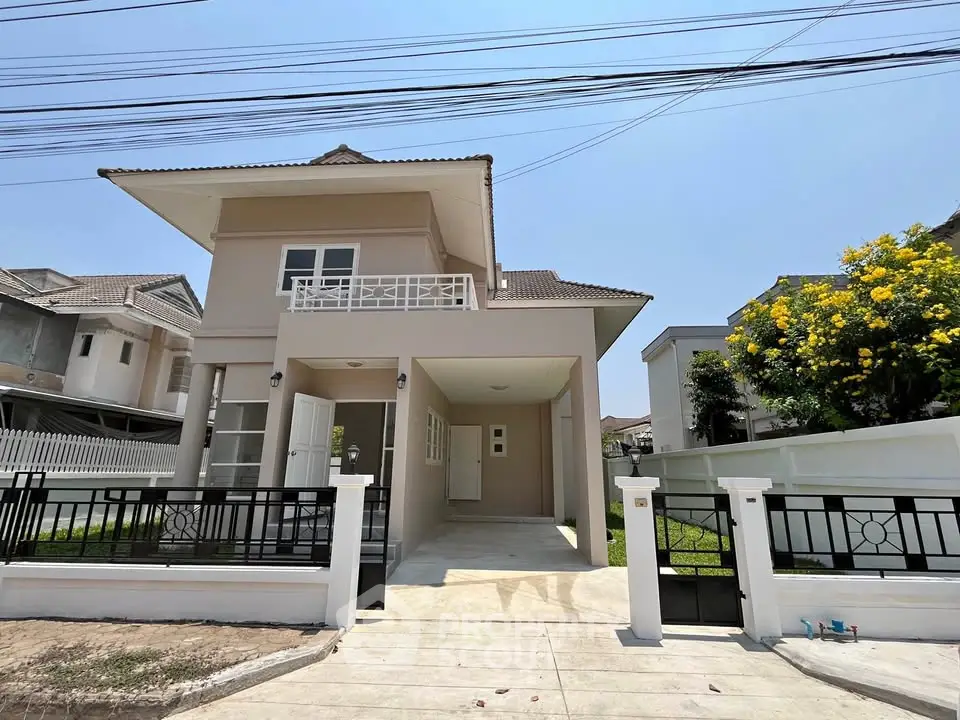 Modern two-story house with spacious driveway and lush garden in a serene neighborhood.