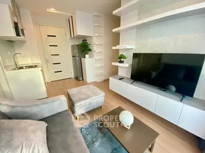 Modern living room with sleek furniture and open kitchen layout, perfect for contemporary living.