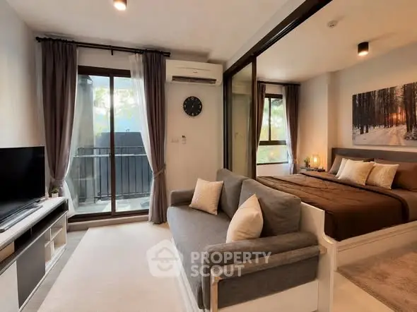 Modern studio apartment with cozy living area and bedroom, featuring a balcony and stylish decor.