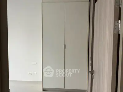 Minimalist interior with white wardrobe and modern door