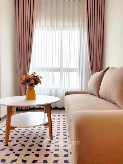 Chic living room with stylish sofa, modern coffee table, and elegant curtains, perfect for cozy relaxation.