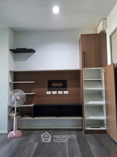 Modern living room with built-in wooden shelves and sleek design