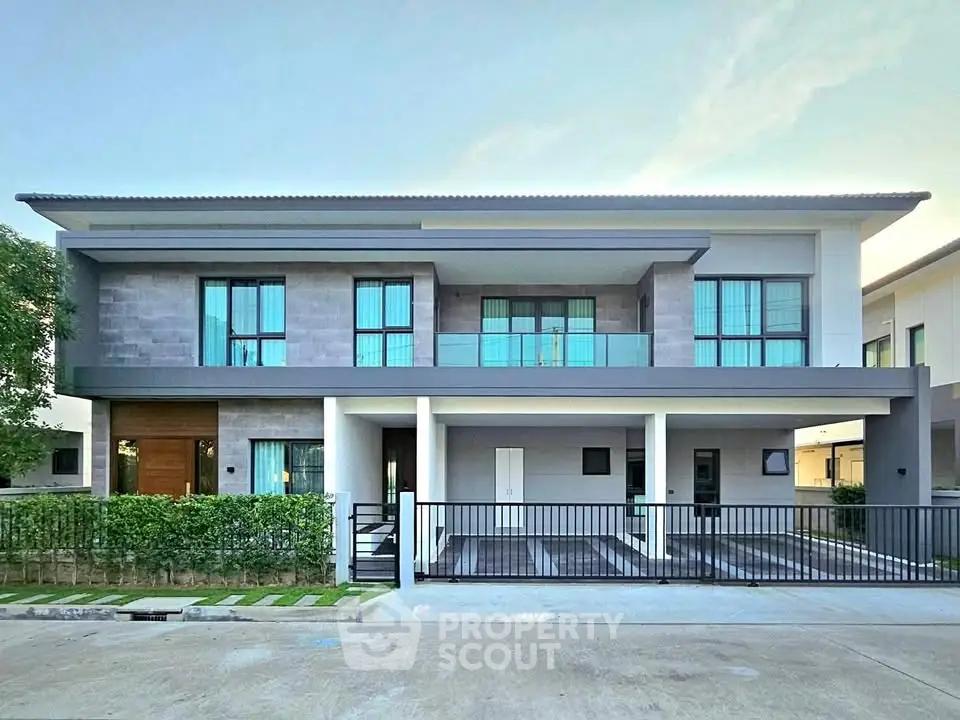 Modern two-story house with sleek design and spacious balcony in a serene neighborhood.