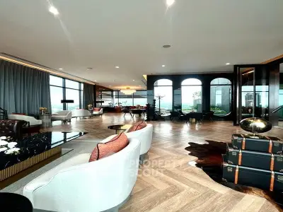 Luxurious open-plan living room with elegant decor and panoramic city views.