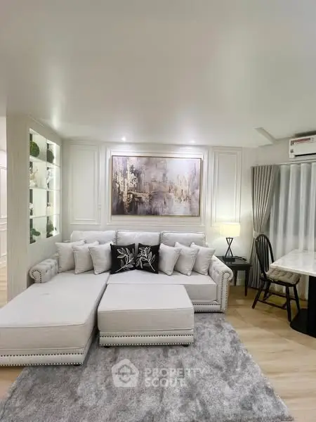 Luxurious living room with elegant decor and plush seating in modern apartment.
