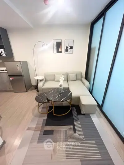 Modern living room with stylish decor and natural light, featuring a cozy sofa and chic coffee tables.