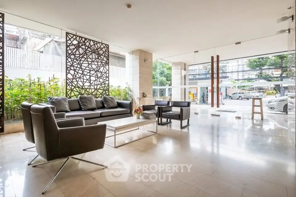 Spacious and modern building entrance with stylish seating area and natural light.