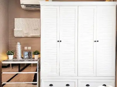Chic bedroom with stylish white wardrobe and modern decor