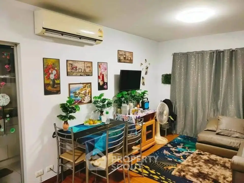 Cozy living room with modern decor, air conditioning, and stylish furniture in a vibrant apartment.