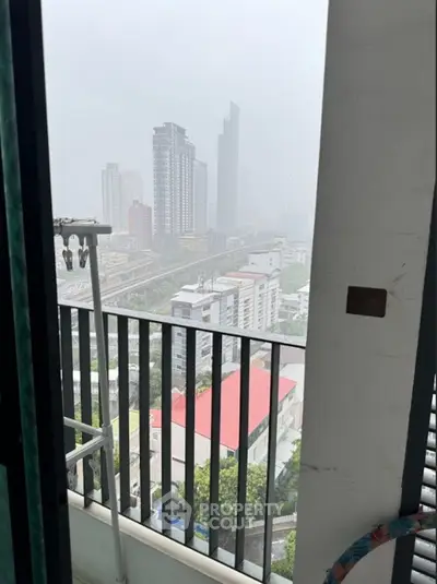 Stunning cityscape view from a high-rise balcony with modern skyscrapers and urban landscape.