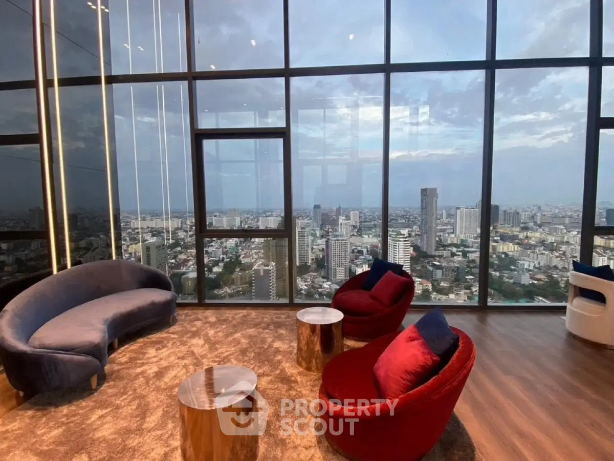 Luxurious high-rise living room with stunning cityscape view through floor-to-ceiling windows.