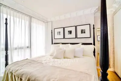 Luxurious bedroom with elegant decor and large windows for natural light.