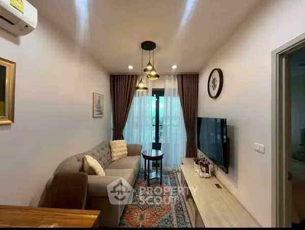 Charming living room with cozy sofa, stylish lighting, and modern TV setup.