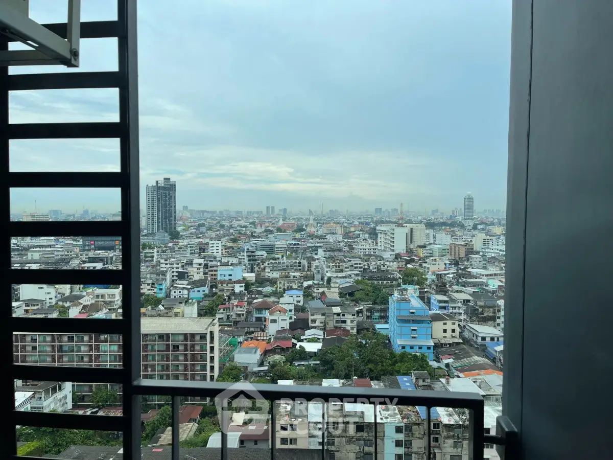 Stunning cityscape view from high-rise balcony showcasing urban skyline.