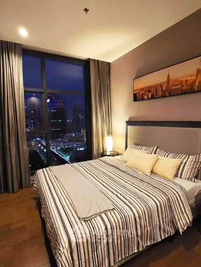 Luxurious bedroom with stunning city view and elegant decor, perfect for urban living.