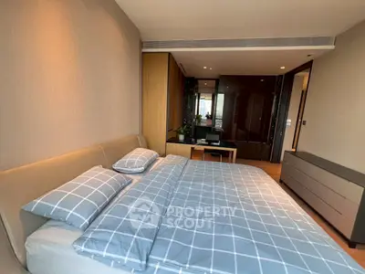Spacious modern bedroom with stylish decor and ample natural light
