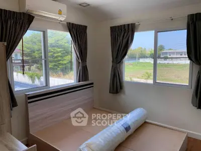 Spacious bedroom with large windows and scenic view, perfect for natural light lovers.