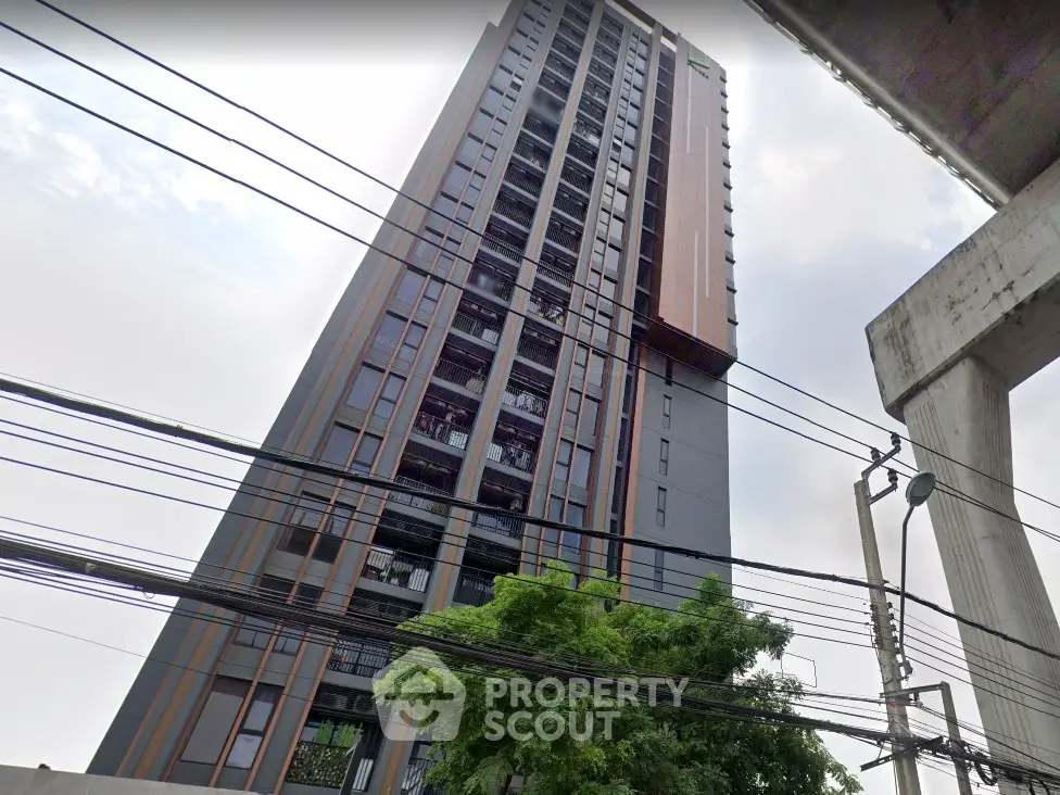 Modern high-rise building with sleek design and urban surroundings
