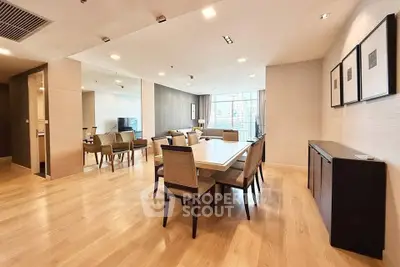 Spacious modern dining area with elegant wooden flooring and stylish decor in a luxury apartment.