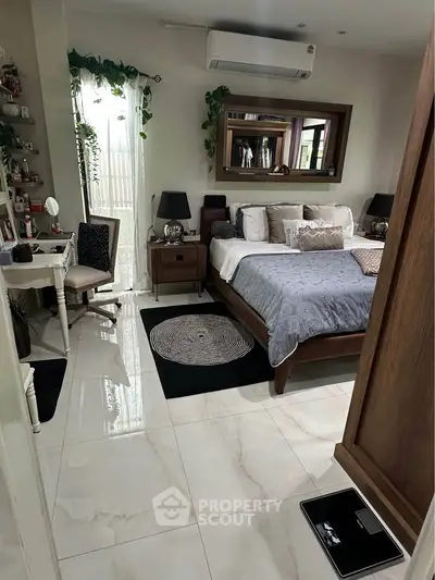 Luxurious bedroom with elegant decor and natural light, featuring a stylish bed and modern furnishings.