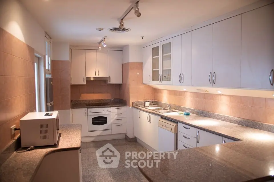 Spacious kitchen with modern appliances and ample storage in a stylish home.