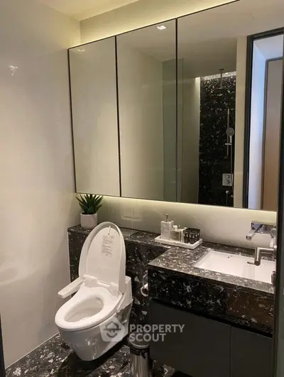 Luxurious modern bathroom with sleek marble finishes and elegant fixtures.